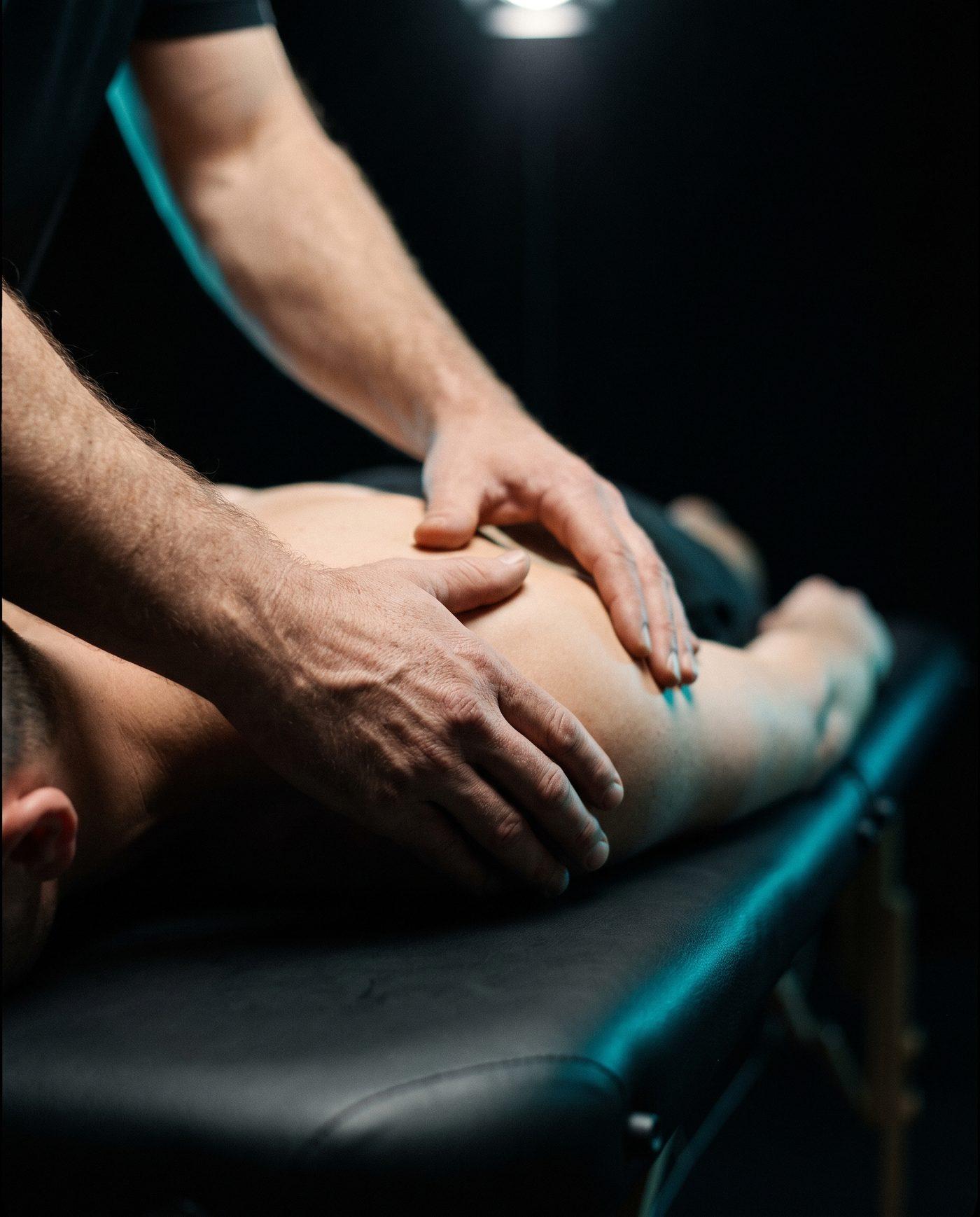 Hands guiding a shoulder through a range-of-motion test